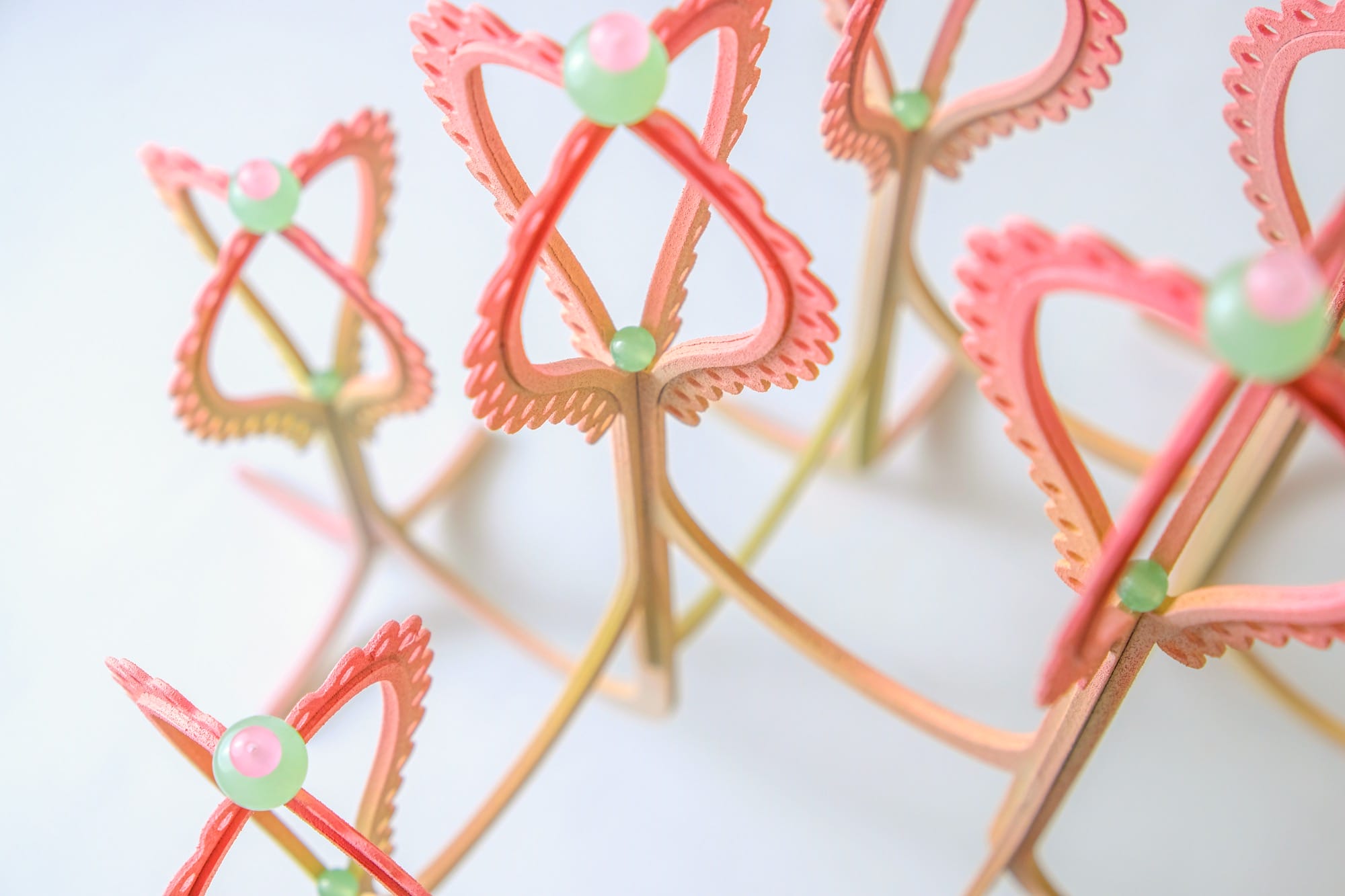 Candy-colored sculptures by Poh Sin Studio depict water-loving creatures blending traditional design with modern art, perfect for nature and art enthusiasts.
