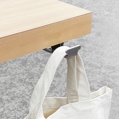 Adding a hidden yet stylish bag hook like Sugatsune’s Slide Hook HK-CS33 can enhance table functionality and style, hiding neatly under tables while preventing trips, perfect for minimalistic designs.