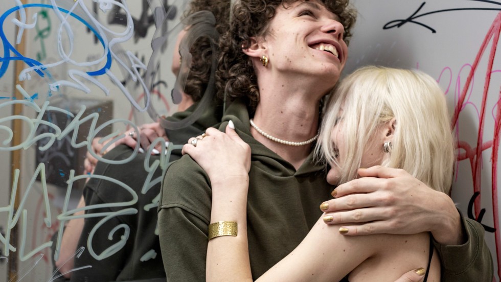 The Karlovy Vary Film Festival uses an embrace motif symbolizing connection, friendship, and love, aiming to bring people together in a divided world.