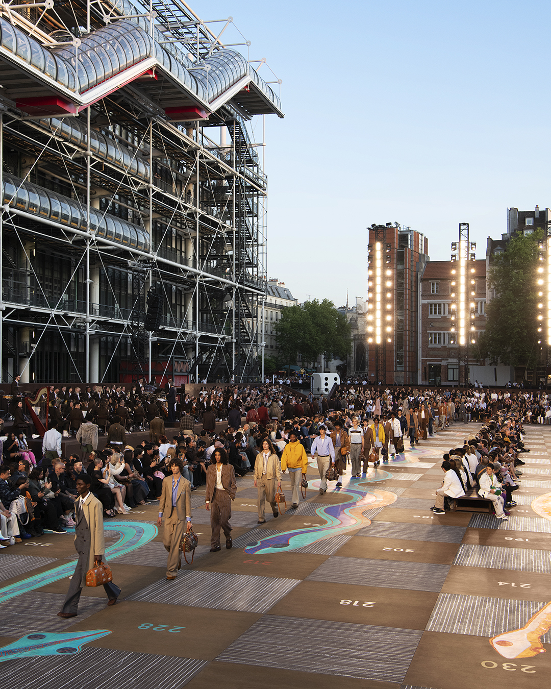YSL and Louis Vuitton collaborate at Paris Fashion Week to showcase how architecture meets fashion through Tadao Ando’s Bourse de Commerce and Bijoy Jain’s Snakes and Ladders-inspired set design.