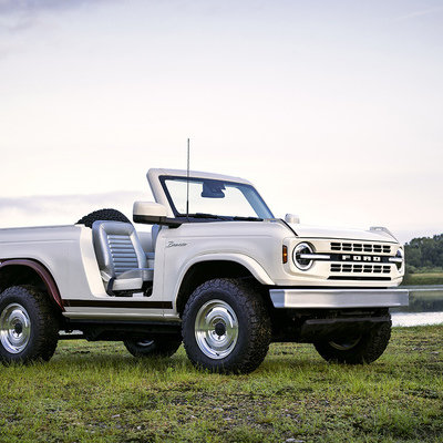 Ford’s Retro Bronco Roadster combines off-road prowess with timeless elegance, featuring Fifteen52 Analog wheels, a modified bumper, fold-down tailgate stamped with ‘FORD,’ and a sleek cockpit, embodying Ford’s innovation while honoring its legacy.