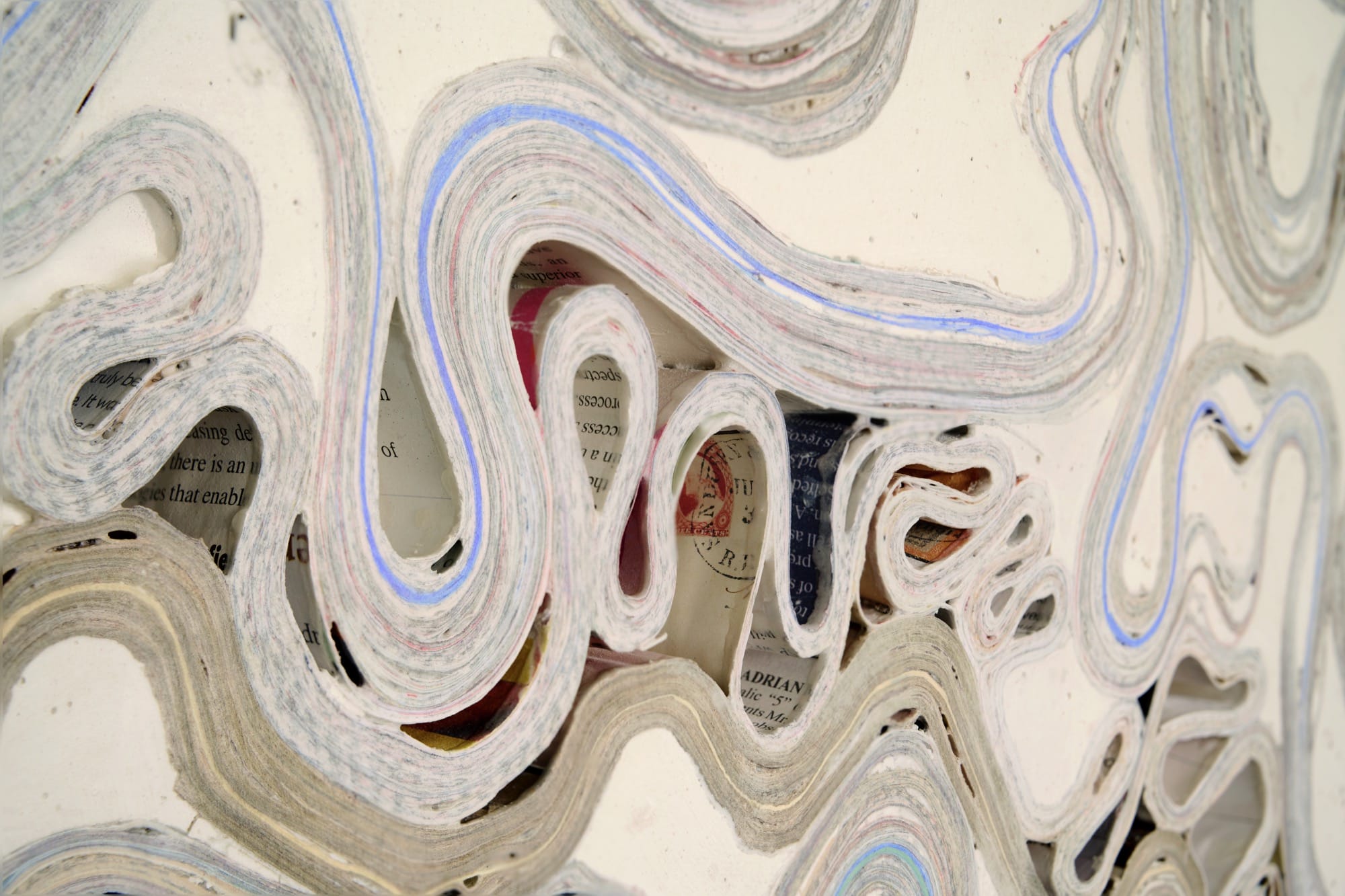 Artist Jessica Drenk creates large-scale wall sculptures using junk mail and found papers